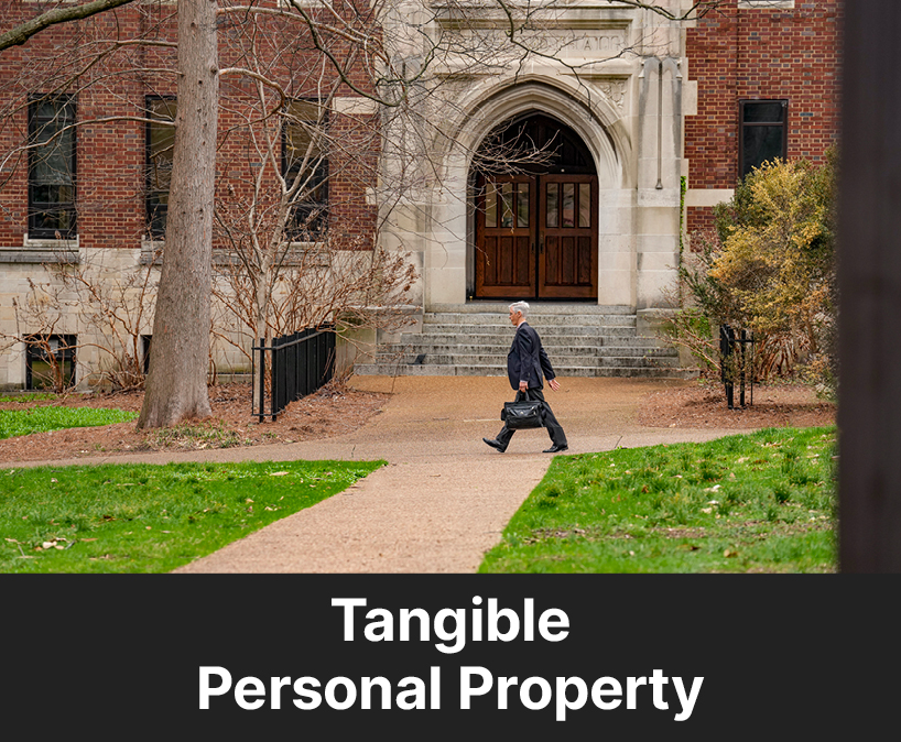 A person walking on campus. Links to Tangible Personal Property